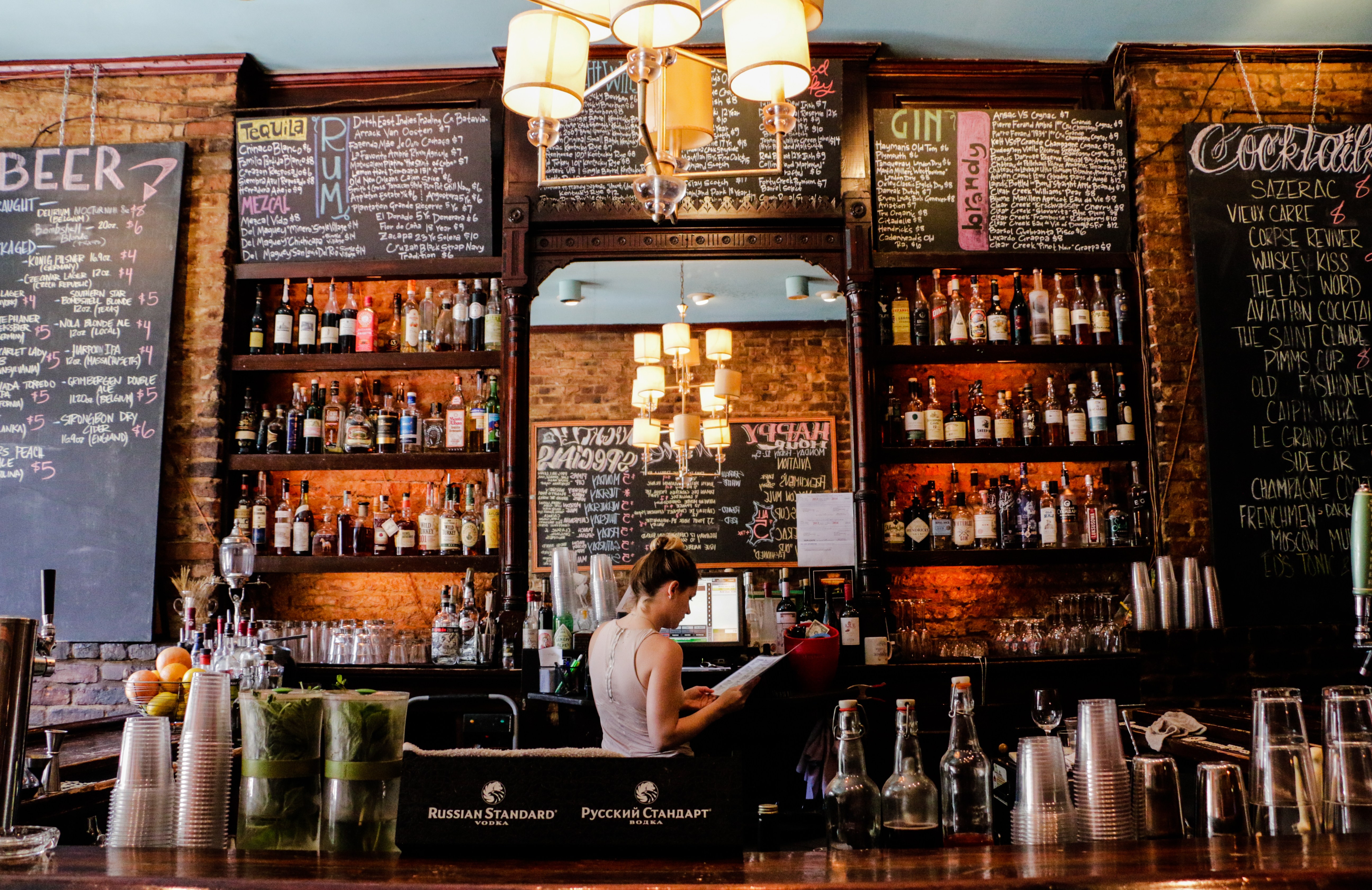 Bar Tonique interior with liquor shelves and chalkboard menus.