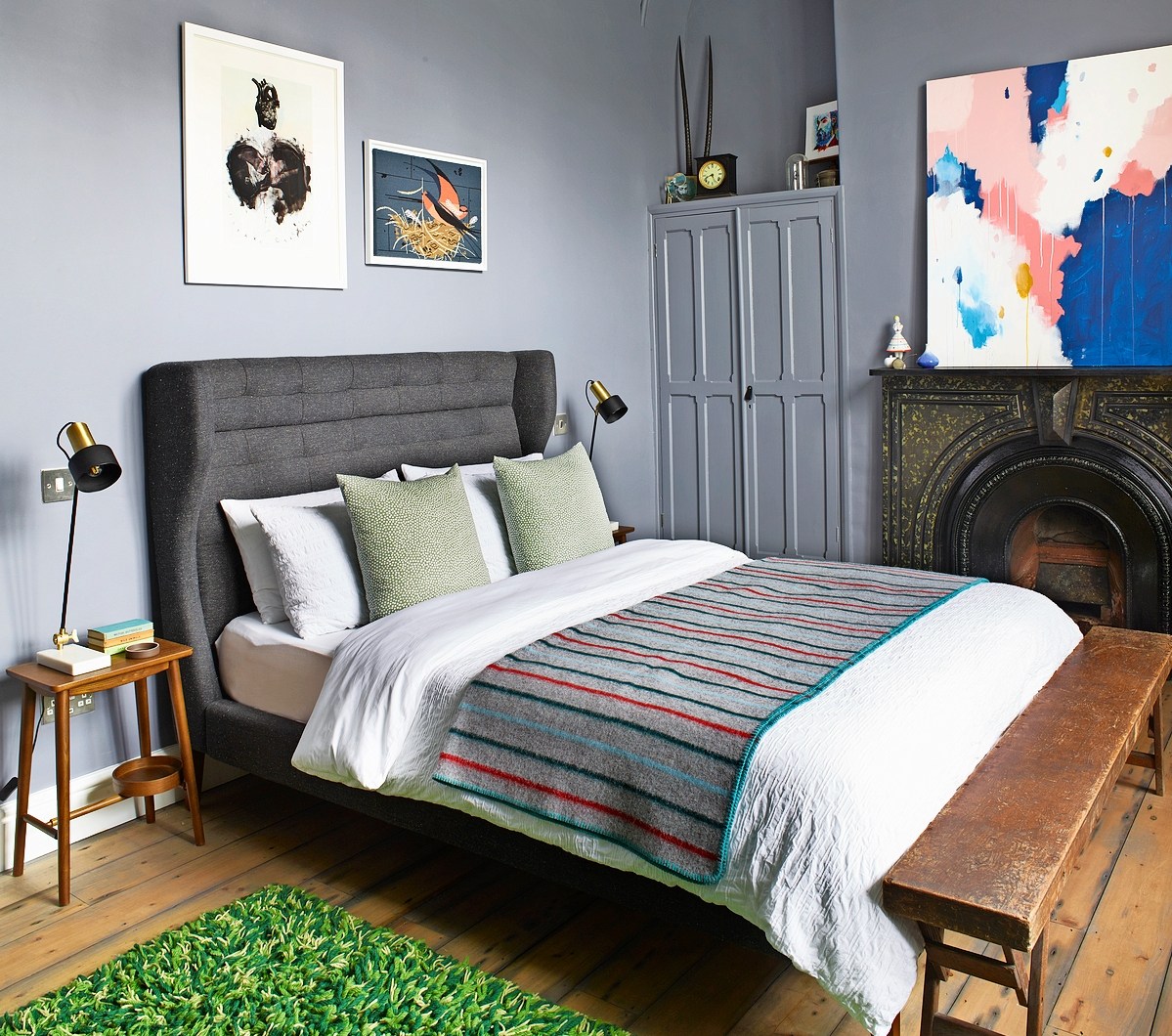 Stylish bedroom at The Royston with grey walls and modern art.