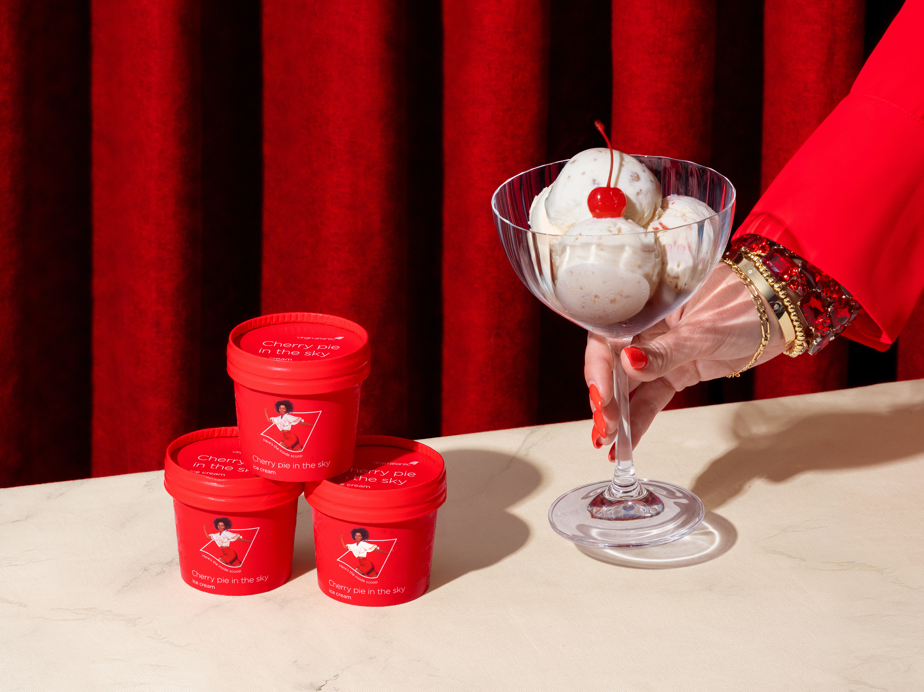 Cherry pie ice cream in a glass and three cups.