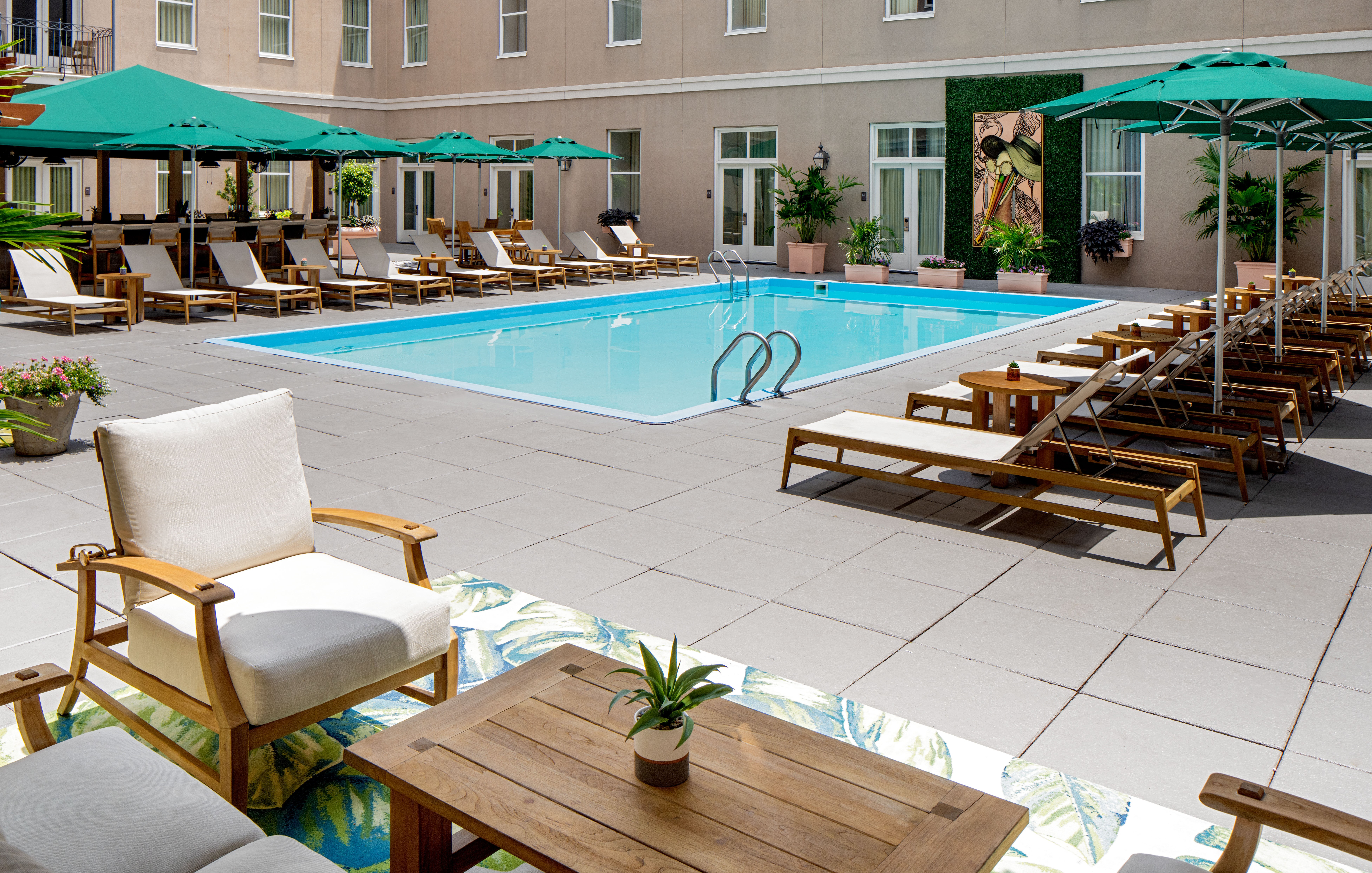 Hyatt Centric French Quarter pool area with lounge chairs and umbrellas.