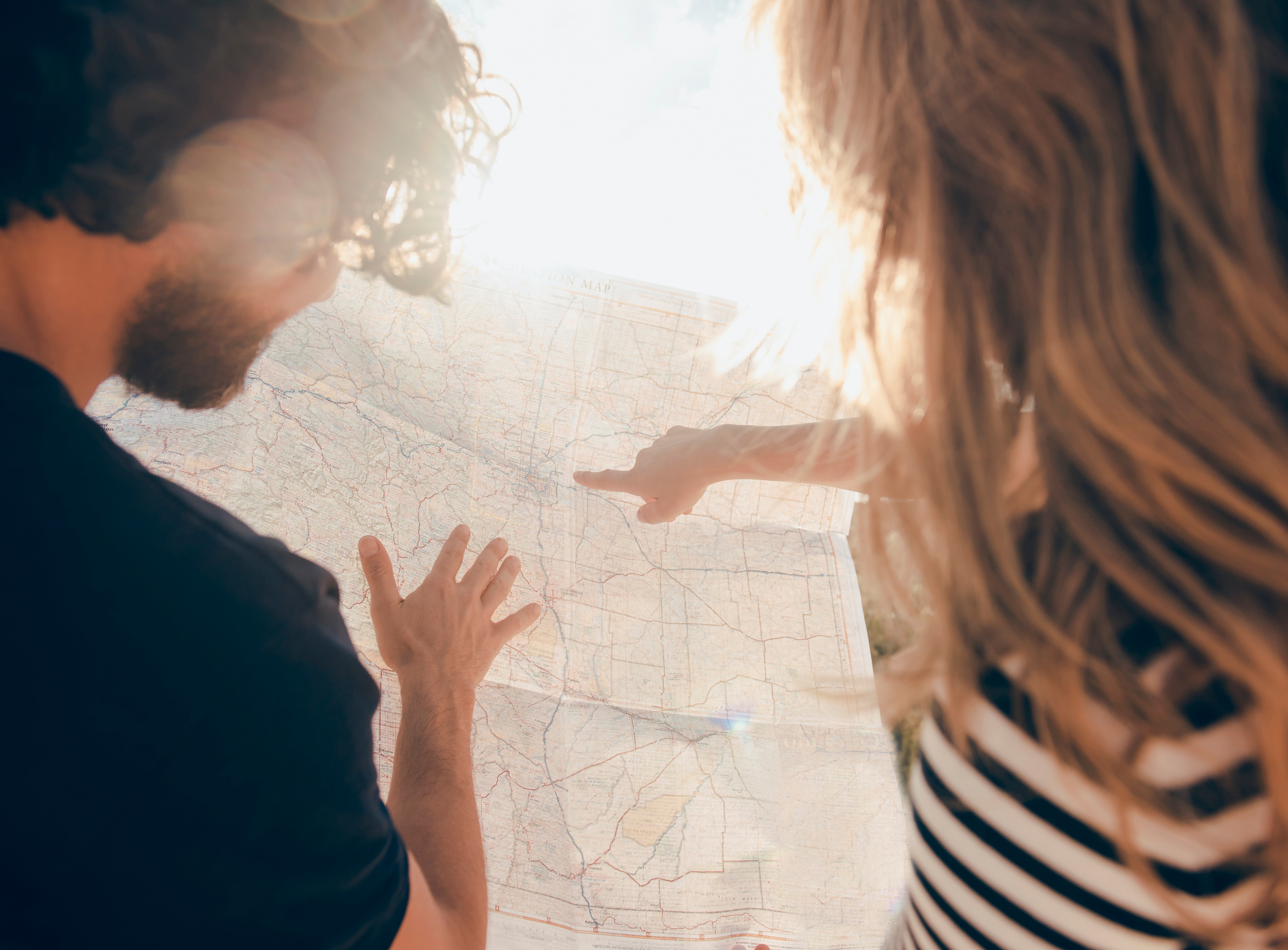 Couple reading a map in the desert.
