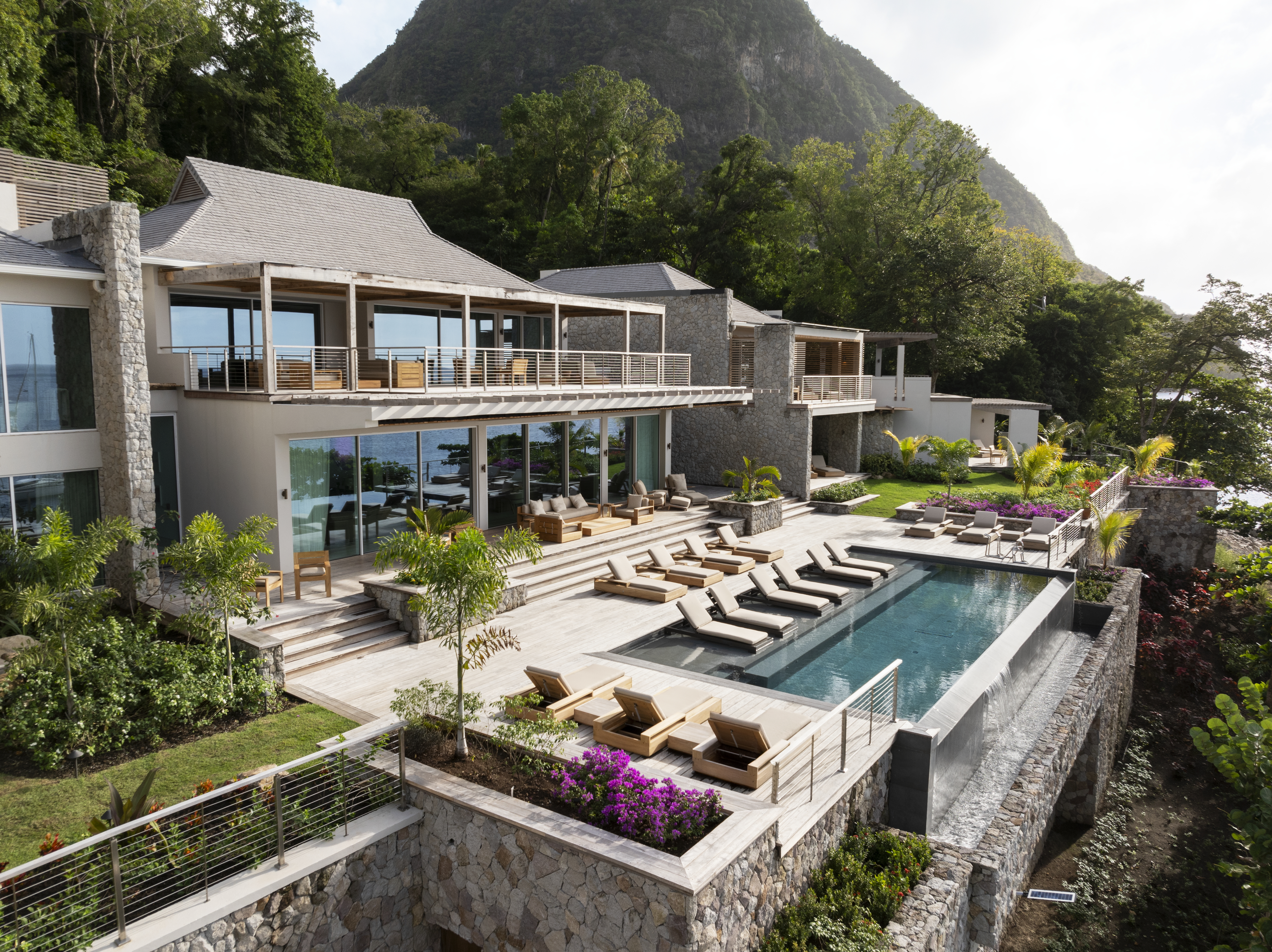 Aerial view of a luxury villa with a pool and lush landscaping in St. Lucia.