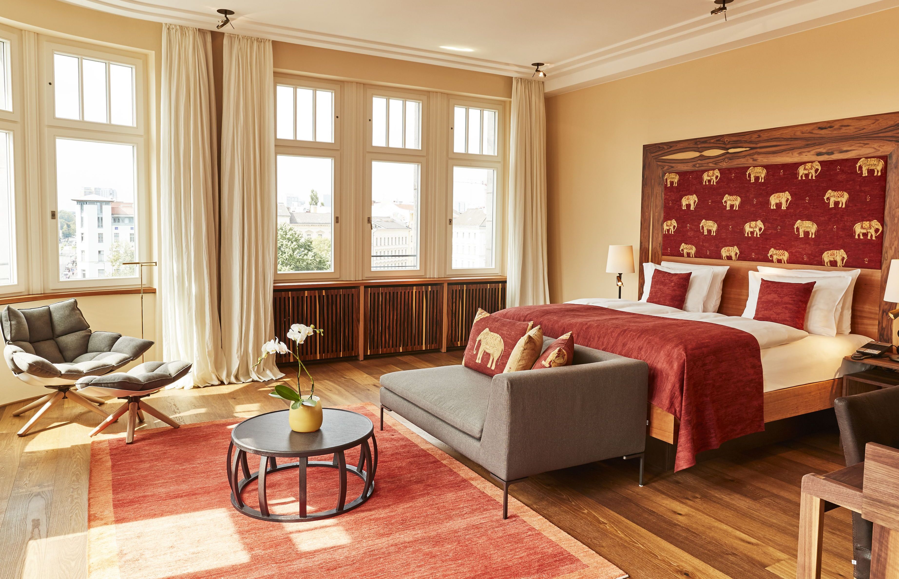 Boutique hotel room with an elephant-patterned headboard.